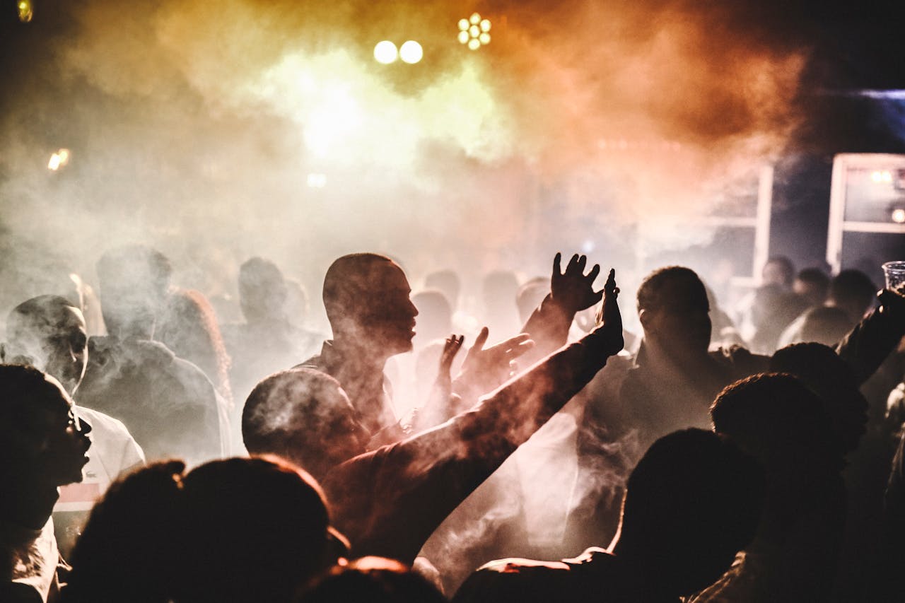 Vibrant nightclub atmosphere with lively crowd and dramatic lighting.